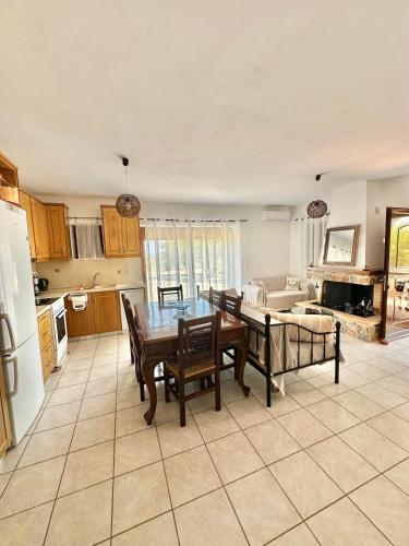 a kitchen and dining room with a table and chairs at Althaea in Monemvasia