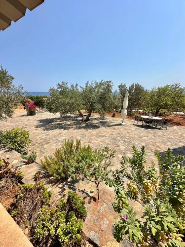 a garden with a picnic table and some trees at Althaea in Monemvasia