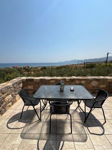 a table and two chairs on a patio with the view at Althaea in Monemvasia