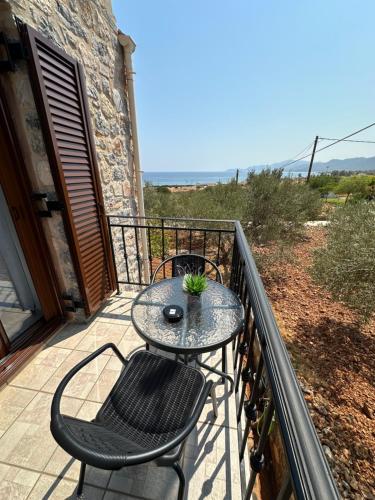 a patio with a table and chairs on a balcony at Althaea in Monemvasia