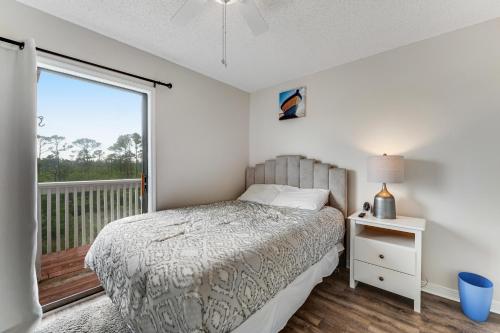 a bedroom with a bed and a balcony at Romar Village 621 in Orange Beach