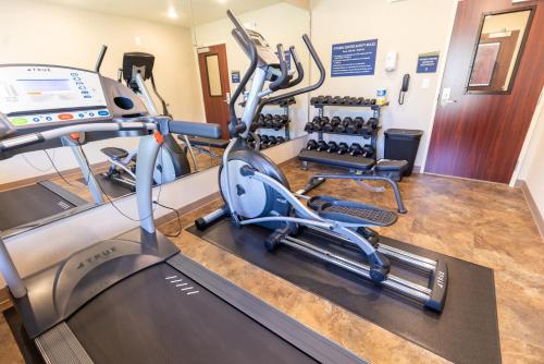 a gym with treadmills and elliptical machines at Cobblestone Inn & Suites - Winters in Winters