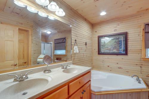 a bathroom with two sinks and a large mirror at Hot Tub, Decks and Creek Access McCaysville Cabin! in McCaysville