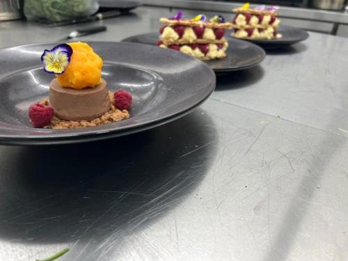 a dessert on a black plate on a table at Alia Suites and Spa in Haraki