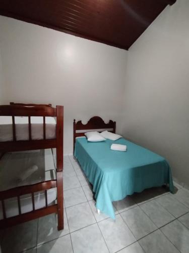 a bedroom with a bed and a bunk bed at Pouso Trindade in Trindade