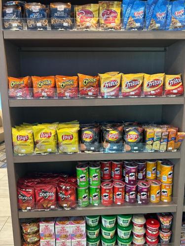 a store shelf filled with lots of bags of food at Holiday Inn Express & Suites Sanford - Lake Mary by IHG in Sanford