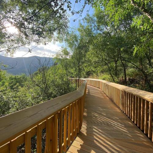 a wooden boardwalk with a view of the mountains at Casa Retiro de Xisto II in Videmonte