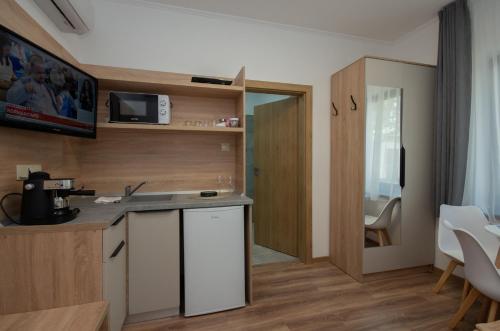 a kitchen with a sink and a counter top at Családi kikötő apartman in Gyula