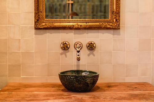 a bowl on a table in a room with a mirror at Senglea Jungle Palazzo in Senglea