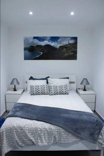a bedroom with a large bed with two night stands at Aligus 1 Apartamento na Horta, Faial, Açores in Horta