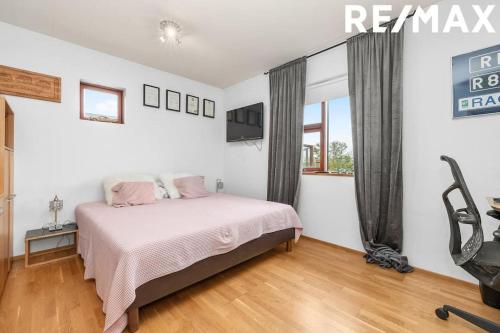 a white bedroom with a bed and a window at Amazing Villa With Hot Tub Near Reykjavík in Lágafell