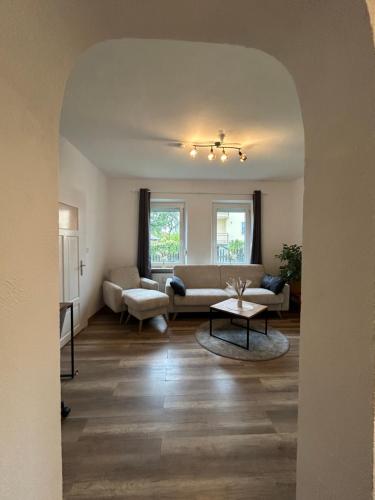 a living room with a couch and a table at Homestay - Ferienwohnung Apfelgarten in Bad Griesbach