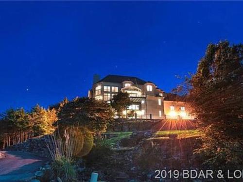 a large house on top of a hill at night at Old Kinderhook Castle in Roach