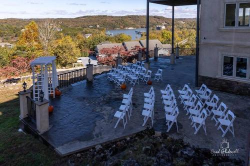 a group of white chairs sitting on a patio at Old Kinderhook Castle in Roach
