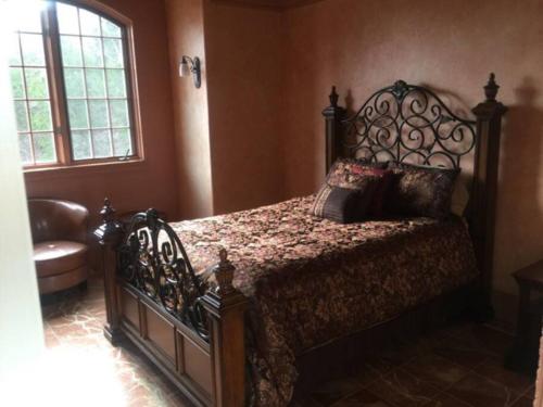 a bedroom with a bed with a wrought iron headboard at Old Kinderhook Castle in Roach