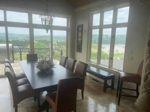a dining room with a table and chairs and windows at Old Kinderhook Castle in Roach