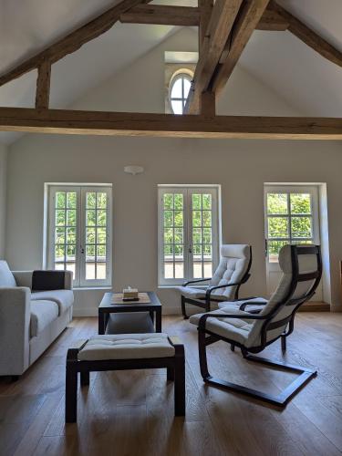 a living room with a couch and two chairs at Domaine de Coeurmandie - Hôtel Château in Bény-sur-Mer