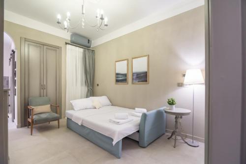 a bedroom with a bed and a table and a chair at To Spitaki in Thessaloniki