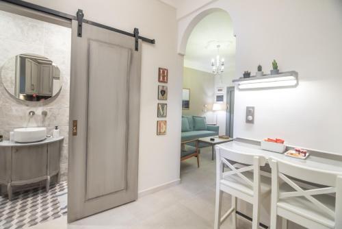 a bathroom with a door leading to a dining room at To Spitaki in Thessaloniki