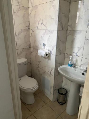 a bathroom with a toilet and a sink at The Oceanic 52 in Durban