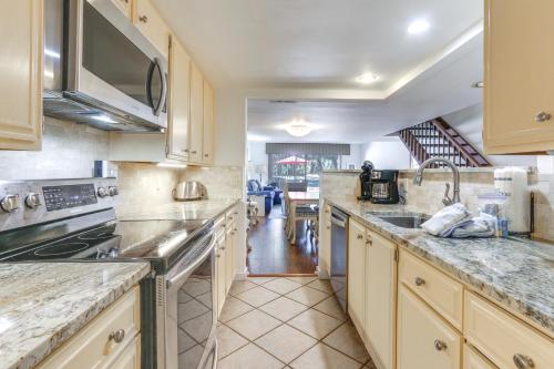 a kitchen with a sink and a stove top oven at Golf Course Views and Beach Access Shipyard Villa in Hilton Head Island