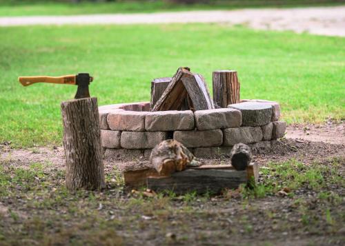 a fire pit made out of rocks and logs at Turn On Inn in Lake Village