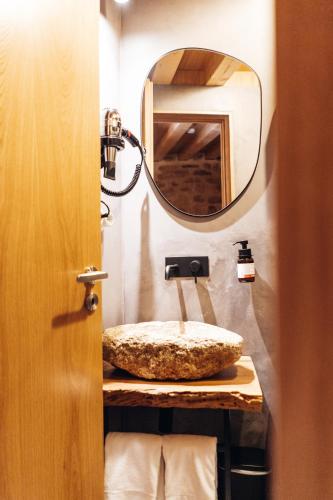 a bathroom with a sink and a mirror at Story Studio Sortelha - Heritage in Sortelha