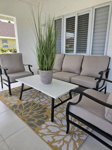 a patio with a couch and a table and chairs at CTBH at The Crest - Richmond Estates Lot 984 3-Bedroom w Pool in Richmond