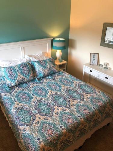 a bedroom with a bed with a colorful bedspread at View Harbor Downtown R and R in Oak Harbor