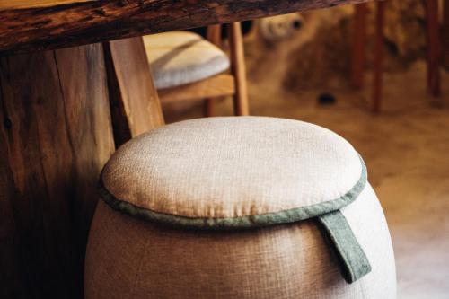 a white chair sitting under a wooden table at Story Studio Sortelha - Heritage in Sortelha