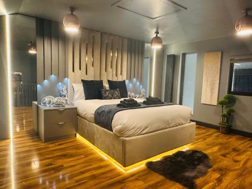 a bedroom with a large bed with a dog laying on the floor at Two Bedroom Apartment in Slough