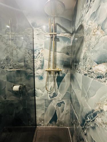 a bathroom with a shower with a mountain mural at Two Bedroom Apartment in Slough