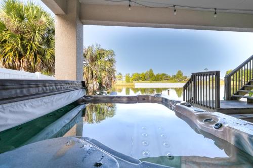 a swimming pool in a house with trees and water at Bright Bayfront Home Less Than 2 Mi to Hernando Beach! in Hernando Beach