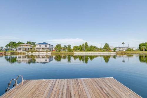 a dock on a body of water with houses at Bright Bayfront Home Less Than 2 Mi to Hernando Beach! in Hernando Beach