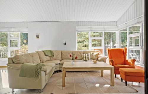 a living room with a couch and a table at Cozy Home In Fjerritslev With Wifi in Fjerritslev