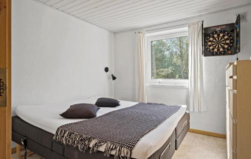 a bedroom with a large bed in front of a window at Cozy Home In Fjerritslev With Wifi in Fjerritslev