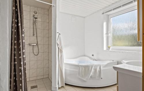 a white bathroom with a tub and a shower at Cozy Home In Fjerritslev With Wifi in Fjerritslev