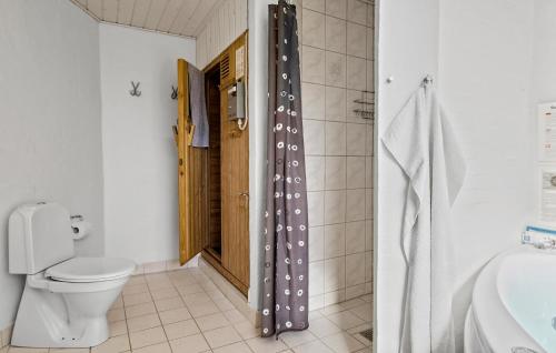 a bathroom with a toilet and a shower curtain at Cozy Home In Fjerritslev With Wifi in Fjerritslev
