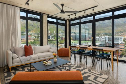 a living room with a couch and a table at Neighbourgood 84 Harrington in Cape Town