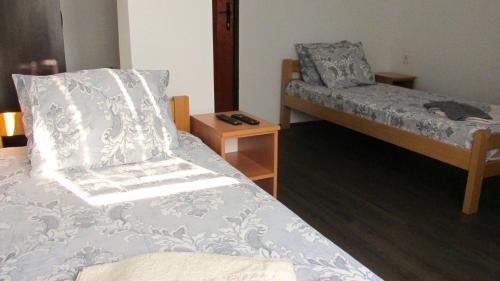 a bedroom with a bed and a bed and a chair at Prenoćište Lipov lad in Negotin