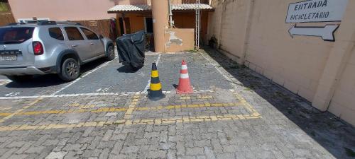 a parking lot with two traffic cones next to a building at COARE0100 - Condominio Aldeia Saint Sebastien in Arembepe