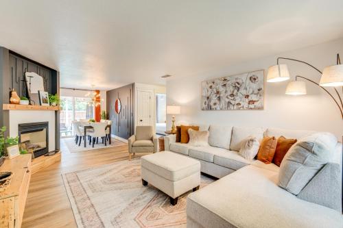 a living room with a couch and a table at Loveland Retreat Near Dtwn with Outdoor Dining! in Loveland