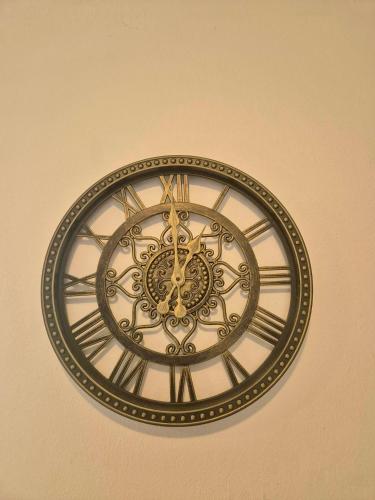 a gold and white clock on a wall at Ocean Front Apartments in Arecibo