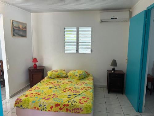 a bedroom with a bed and a window at LA DESIOR in Saint-Louis