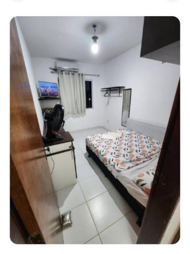 a bedroom with a bed and a phone in it at Salvador 50m Praia com Piscina Prox Aeroporto in Salvador