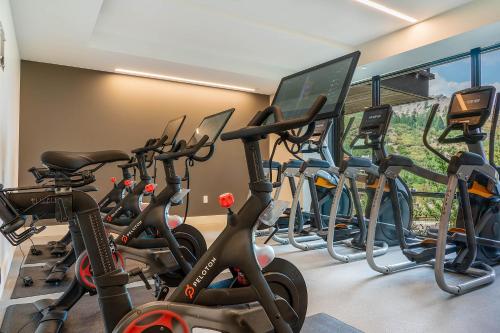 a row of exercise bikes in a gym at One Snowmass West 503 by Snowmass Mountain Lodging in Snowmass