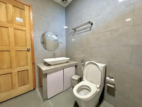 a bathroom with a toilet and a sink at La Solara Villa in Ukulhas