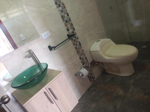 a bathroom with a sink and a toilet at Feliz Amanecer in Sáchica