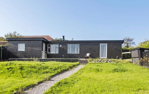 a black house with a green yard at 2 Bedroom Lovely Home In Thisted in Thisted