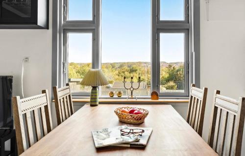 a dining room with a table and chairs and a window at 2 Bedroom Lovely Home In Thisted in Thisted